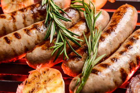 Delicious sausages cooking on grill, closeupの写真素材