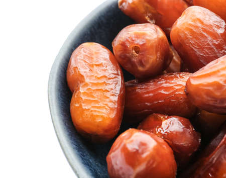 Bowl with sweet dried dates on white backgroundの写真素材