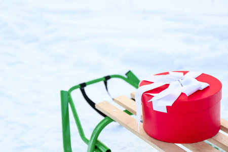 Sledge with gift box on snowy dayの写真素材