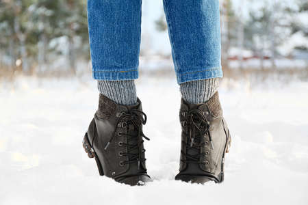 Legs of stylish young woman on snowy day