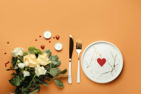 Festive table setting for Valentines Day celebration on color backgroundの写真素材