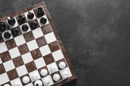 Chess pieces with game board on dark background