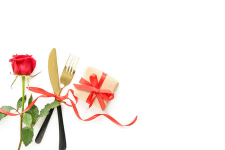 Cutlery with rose flower and gift for Valentines Day on white backgroundの写真素材