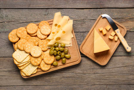 Crunchy crackers and cheese on wooden backgroundの写真素材