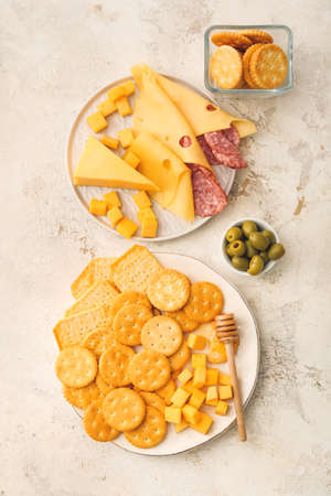 Crunchy crackers with cheese, sausages and honey on grunge backgroundの写真素材