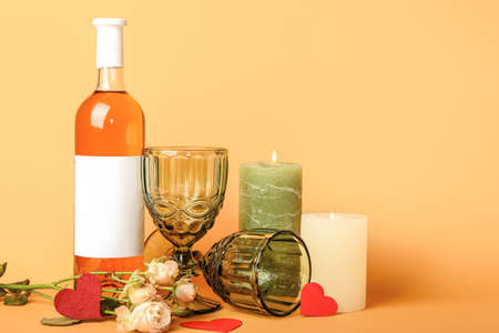 Bottle of wine and glasses for Valentines Day celebration on color background
