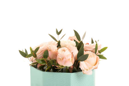 Gift box with bouquet of beautiful flowers on white backgroundの写真素材
