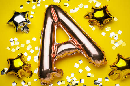 Balloon in shape of letter A on color backgroundの写真素材