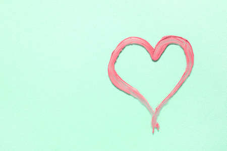 Heart drawn with lipstick on color backgroundの写真素材