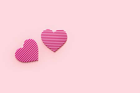 Striped pink hearts on color backgroundの写真素材