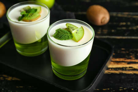 Glasses of tasty jelly on dark wooden backgroundの写真素材