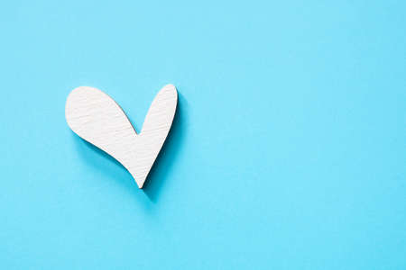 Wooden heart on color backgroundの写真素材