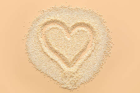 Heart made of quinoa on color backgroundの写真素材