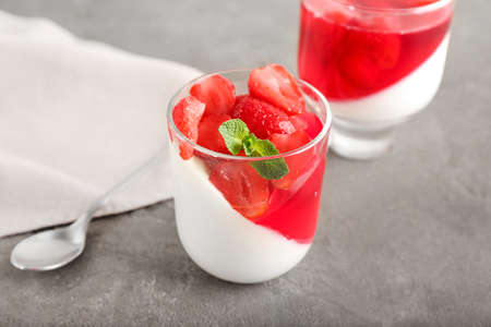 Glasses of tasty strawberry jelly on gray backgroundの写真素材