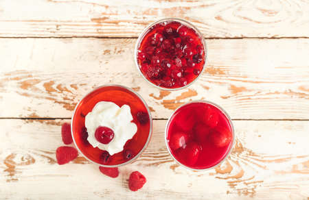 Glasses of tasty jelly on light wooden backgroundの写真素材