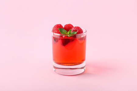 Glass of tasty jelly on color backgroundの写真素材