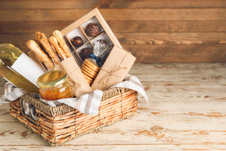 Gift basket with products on wooden backgroundの写真素材