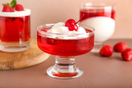 Glasses of tasty raspberry jelly on color backgroundの写真素材