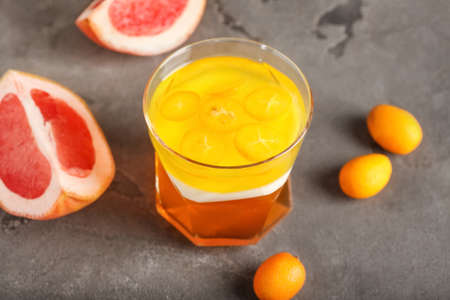 Glass of tasty jelly on gray backgroundの写真素材