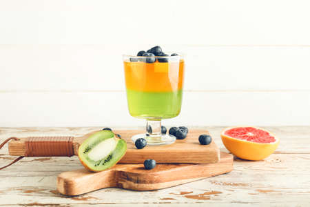 Glass of tasty jelly on light wooden backgroundの写真素材