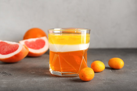 Glass of tasty jelly on gray backgroundの写真素材