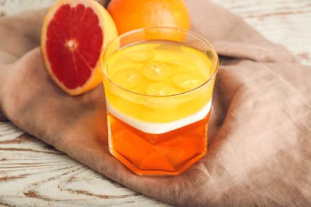 Glass of tasty jelly on light wooden backgroundの写真素材