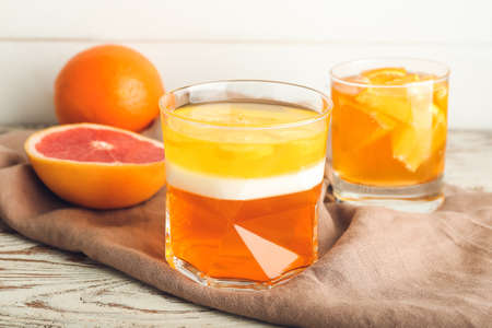 Glass of tasty jelly on light wooden backgroundの写真素材