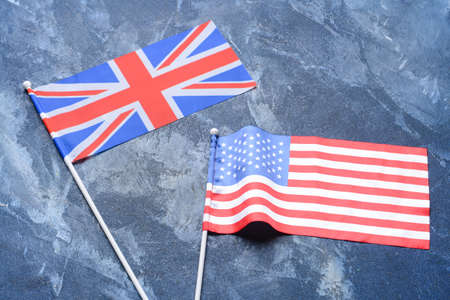 Flags of USA and Great Britain on color background