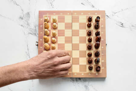 Man playing chess on light background