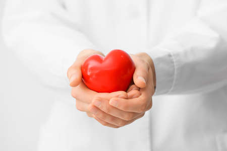 Doctor with red heart, closeupの写真素材