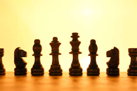 Chess pieces and game board on color backgroundの写真素材