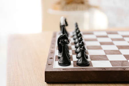 Chess pieces with game board on blurred background