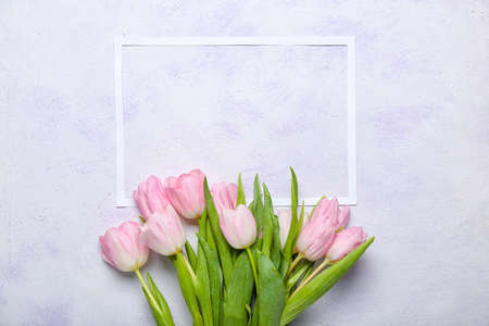Frame with beautiful flowers on light backgroundの写真素材