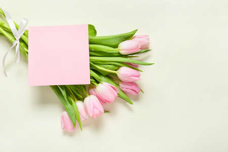 Beautiful flowers and empty card on white backgroundの写真素材