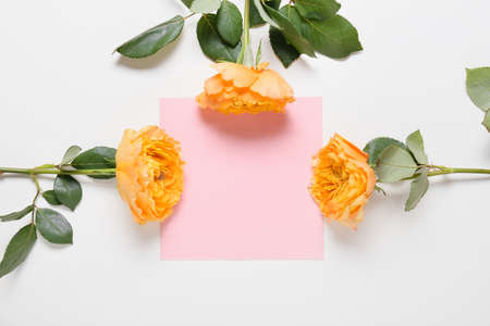 Beautiful flowers and empty card on white backgroundの写真素材