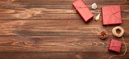 Christmas gifts and decorations on wooden background with space for text