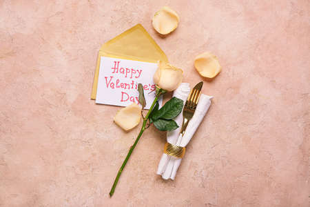 Cutlery and envelope on color background. Valentines Day celebrationの写真素材