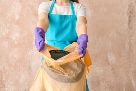 Janitor with garbage on color backgroundの写真素材
