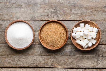 Bowls with different sugar on wooden backgroundの写真素材