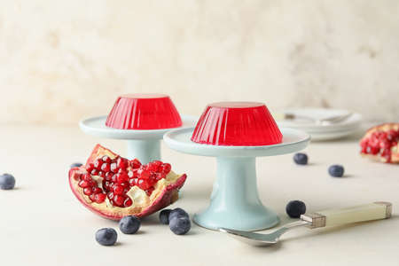 Dessert stands with tasty berry jelly on light backgroundの写真素材