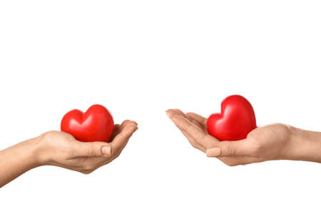 Hands with red hearts on white background