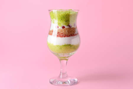 Glass with sweet sugar on color backgroundの写真素材