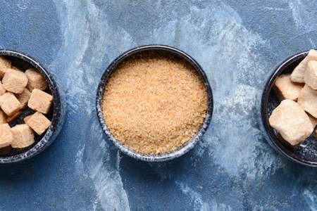 Bowls with sugar on color backgroundの写真素材