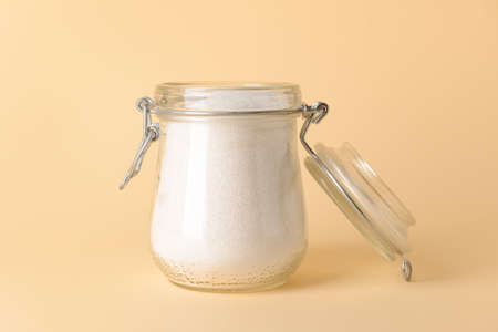 Jar with sweet sugar on color backgroundの写真素材