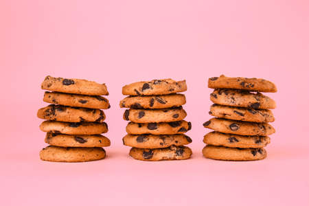 Tasty chocolate chips cookies on color backgroundの写真素材