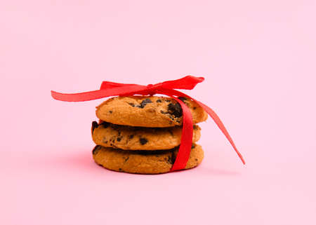 Tasty chocolate chips cookies on color backgroundの写真素材