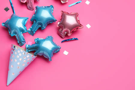 Beautiful balloons and party hat on pink backgroundの写真素材