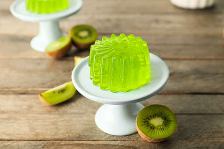 Dessert stand with tasty kiwi jelly on wooden backgroundの写真素材