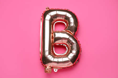 Balloon in shape of letter B on pink backgroundの写真素材
