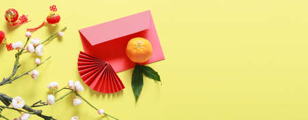 Red envelope with Chinese symbols on yellow background with space for textの写真素材